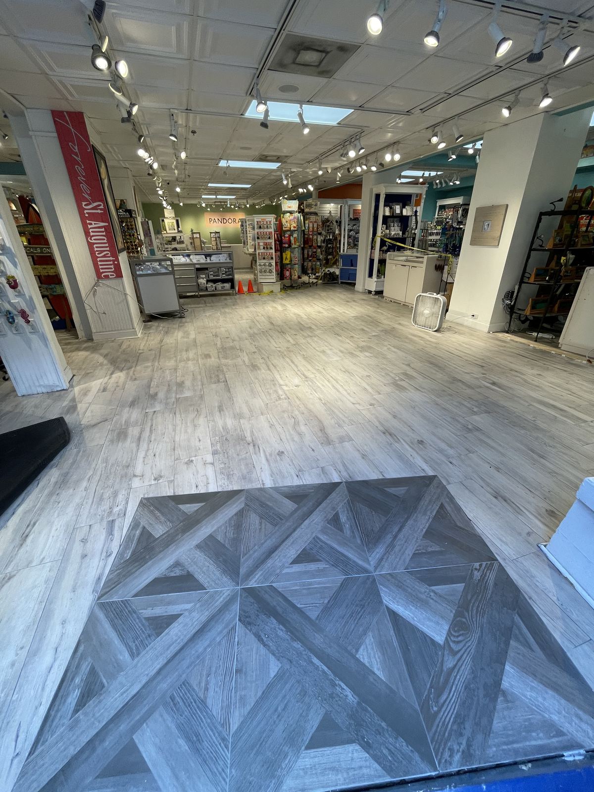 Finished wood-look tile flooring with herringbone inset
